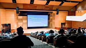 Photo of a large lecture hall filled with attendees